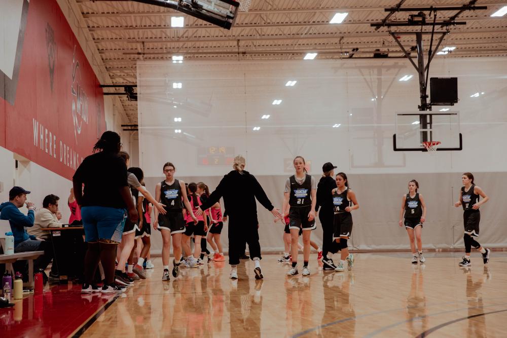 Players and coach congratulating each other.